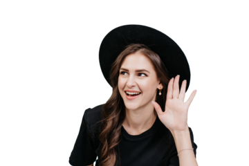Young woman trying to hear new gossip, secret. Smiling woman with black hat waving hello, transparent backdrop.