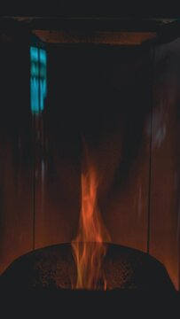 Vertical time lapse of a pellet stove, view of the hearth, flame decreasing in intensity