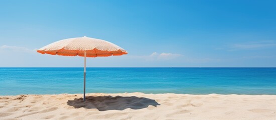 Serenity at Shore: A Beach Umbrella Brings Calm to a Sun-Kissed Sandy Beach