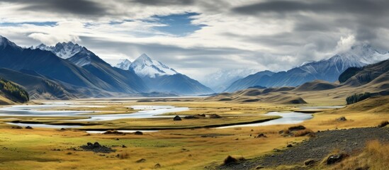 Majestic Altai Valley: A Serene River Flows Through Dramatic Autumn Mountains and Clouds