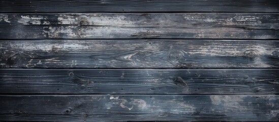 Obraz premium Weathered Wooden Wall Revealing Layers of History and Time Through Peeling Black Paint