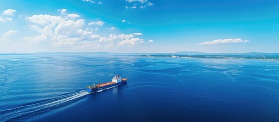 Majestic Tug Boat Assisting an Empty Barge Through the Vast Blue Ocean - obrazy, fototapety, plakaty