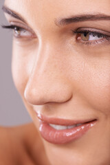 Fototapeta premium Beauty, skincare and face of woman in studio for wellness, dermatology and facial treatment. Luxury salon, spa and closeup of happy person with makeup, cosmetics and healthy skin on gray background