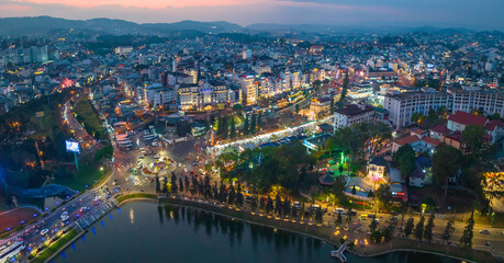 Da Lat, Vietnam - February 21st, 2024: Da Lat city night with urban areas, markets, sparkling...