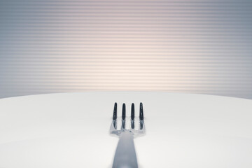 Fork on a white plate filled with water. Minimal image with copy space.