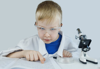 Child chemist. Teacher shows a visual experiment. A science mentor teaches an experimental...