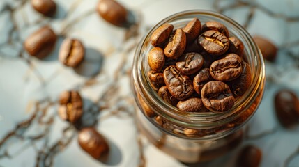 coffee beans in a glass jar on the marble countertop 
