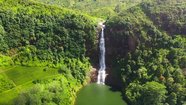 Beautiful waterfall in the mountains among tea plantations. Gartmore falls. Maskeliya, Sri Lanka.