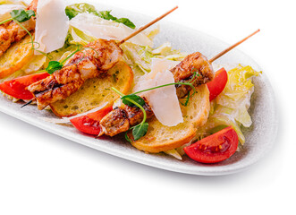trendy Caesar salad with chicken on wooden skewers