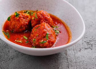 Meatballs with tomato sauce and parsley