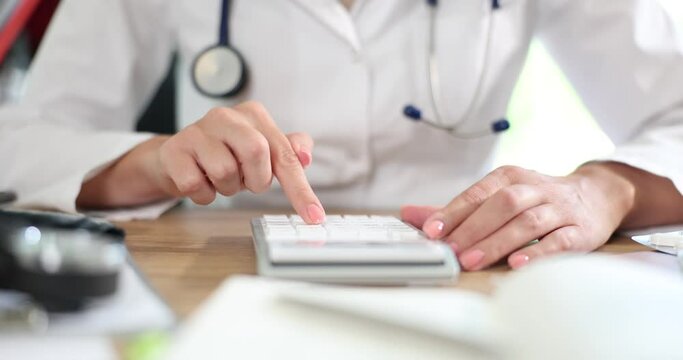 Doctor hand used calculator for medical expenses. Health care or medical insurance cost symbol