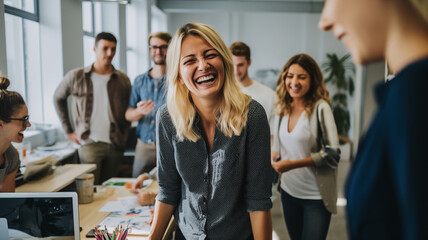 Senior creative director laughing with happy young designer people working together in office.