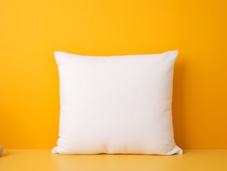 Hand holding a white pillow in a creative studio space vibrant yellow background blank mock-up products suitable for brand photography.