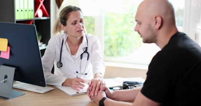 Hands of friendly female doctor hold male patient hand for encouragement and sympathy. Partnership trust and medical ethics concept
