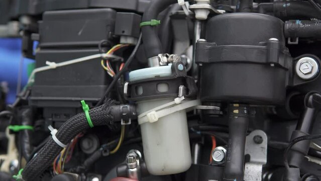 Close-up of the mechanism of an injection boat motor. Repair of two-stroke and four-stroke injection and carburetor engines.