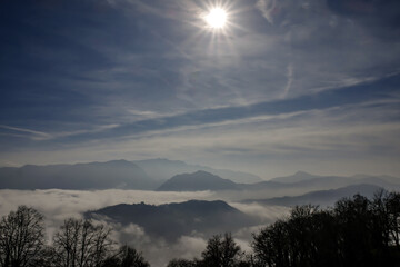 Fototapeta premium Mountain Peak Above Cloudscape in a Sunny Day in Lugano, Ticino in Switzerland.