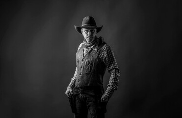 Fototapeta na wymiar Man wearing cowboy hat, gun. West, guns. Portrait of a cowboy. Cowboy with a pistol, guy in a cowboy hat with a gun. Western man with hat. Black and white