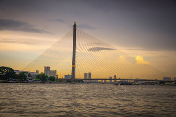 Sunset Silhouette of Rama VIII Bridge over Chao Phraya River, Bangkok, Thailand