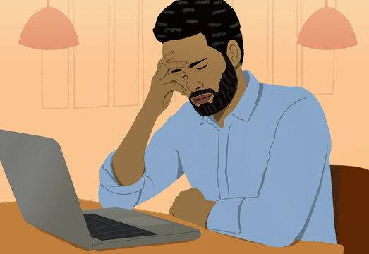 Frustrated man working from home at laptop
