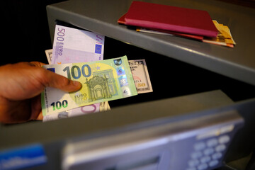 closeup male hands holds 50, 500 euro banknotes of european union, personal documents, tourist puts...