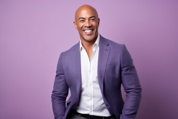 Portrait of a handsome african american man smiling against purple background - obrazy, fototapety, plakaty