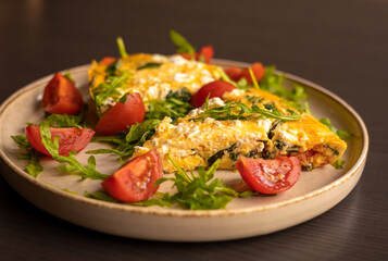 delicious spring frittata for a perfect brunch with arugula and cherry tomatoes close-up