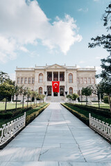 Fototapeta na wymiar Dolmabahce sarayi palace in Besiktas Istanbul. Fasade with national turkish flag.