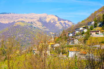 Fototapeta na wymiar Muggia Valley with Village and Mountain in a Sunny Day in Ticino, Switzerland