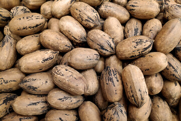 Stack of pecan nuts on a market stall