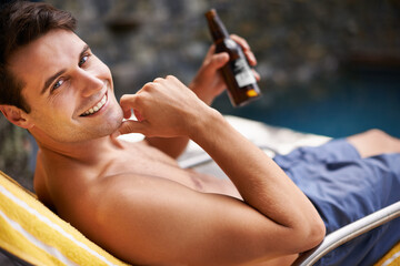 Portrait, man and relax by swimming pool with beer to drink or chill on summer vacation, luxury and...