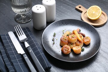 Delicious fried scallops served on dark gray textured table