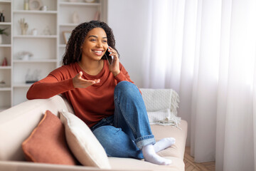 Pleasant Chat. Happy Young Black Woman Talking On Cellphone At Home