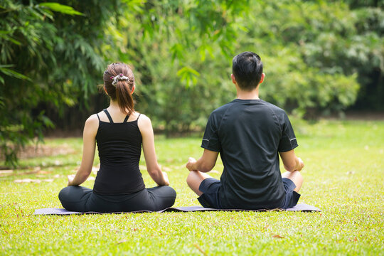 Chinese man practicing Tai Chi outdoors.