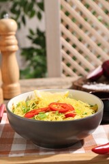 Stir-fry. Tasty noodles with vegetables and meat in bowl on table
