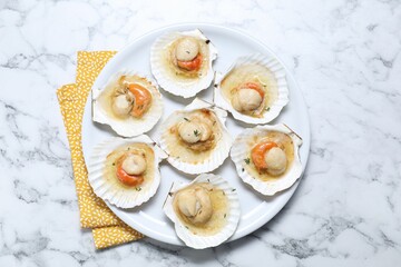 Fried scallops in shells on white marble table, top view