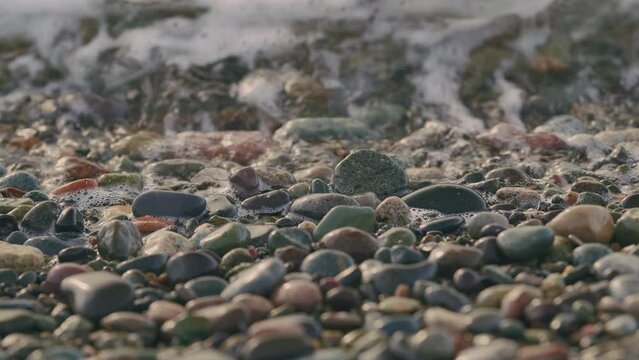 Beach Is Covered With Pebble. Small Sea Waves. Waves Crashing On A Beach.