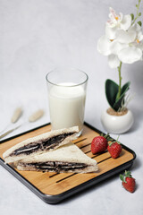 oreo cream sandwich with milk and strawberries