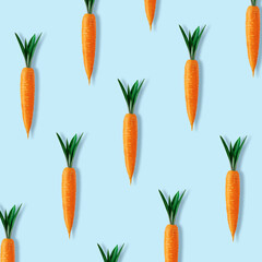 Creative Easter pattern made with carrots on blue background. Minimal Easter composition.Flat lay.