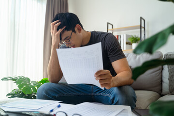 The men is stressed when he see invoice documents, credit card debt, loans, taxes.