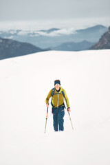 Fototapeta na wymiar A man goes solo skiing