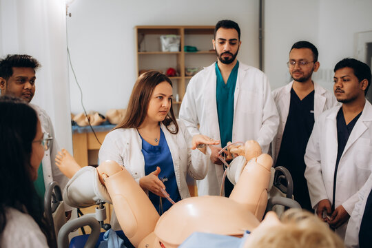 Students of the gynecology faculty practice giving birth using a mannequin