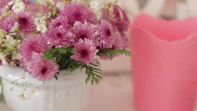 Floral arrangement of pink Chrysanthemums in porcelain vase with copy space