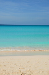 Fototapeta na wymiar Tropical beach landscape, soft turquoise sea, clear sandy beach, blue sky