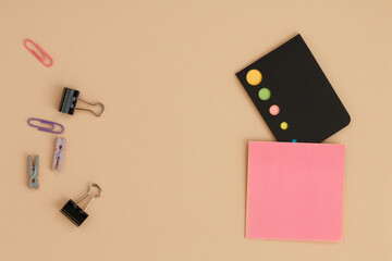 Office supplies top view with pink sticky notepad. 