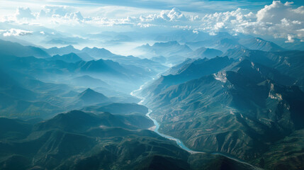 Mountain and lake landscape with snowy peaks, azure waters, and a cloudy sky captured from an aerial perspective