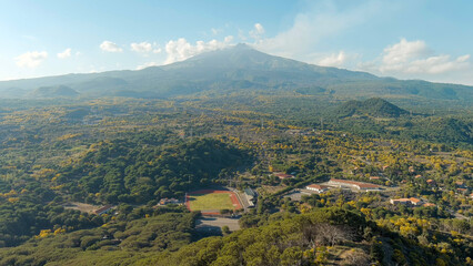 Fototapeta na wymiar Nicolosi, Sicily, Italy. Volcanic craters overgrown with forest on the slopes of Mount Etna, Aerial View