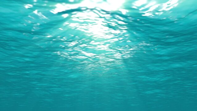 Underwater loop background animation. Light rays shining through ocean surface.