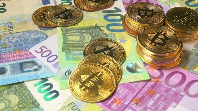 A cache with bunch euro bills and bitcoin gold coins cryptocurrency stacks, slow rotation, money background video. Wealth and making profit. B-roll for e-commerce. 