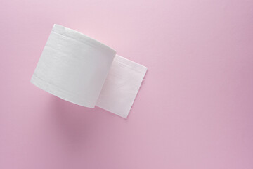 Creative layout of toilet paper roll on pink background. Minimal Coronavirus outbreak. Panic concept.