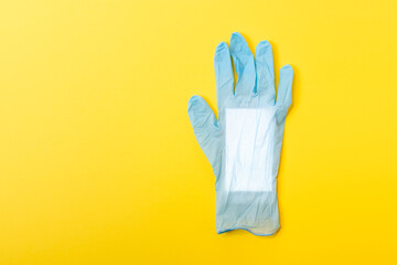 Blue latex medical glove with mobile phone inside. Minimal Coronavirus outbreak. Pandemic concept.